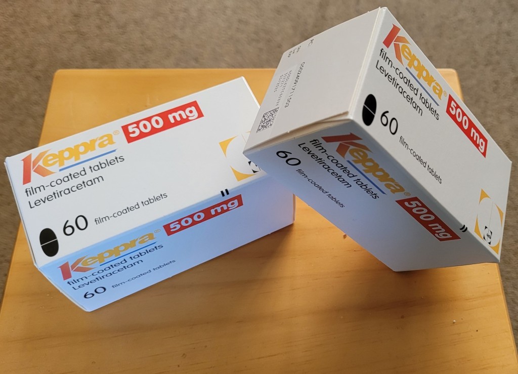 Two white boxes of Keppra epilepsy medication on a table.